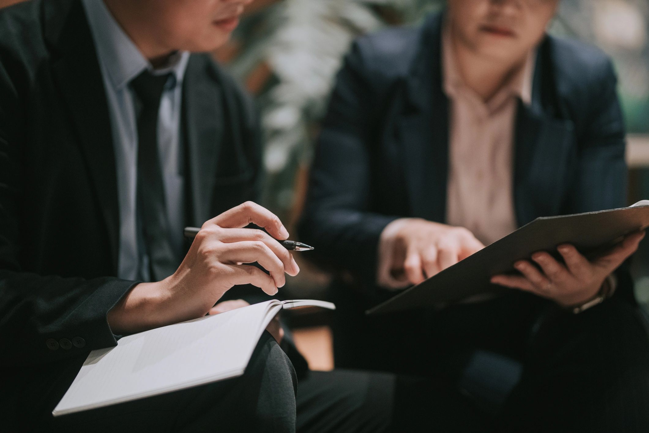 Leader taking notes during a coaching conversation