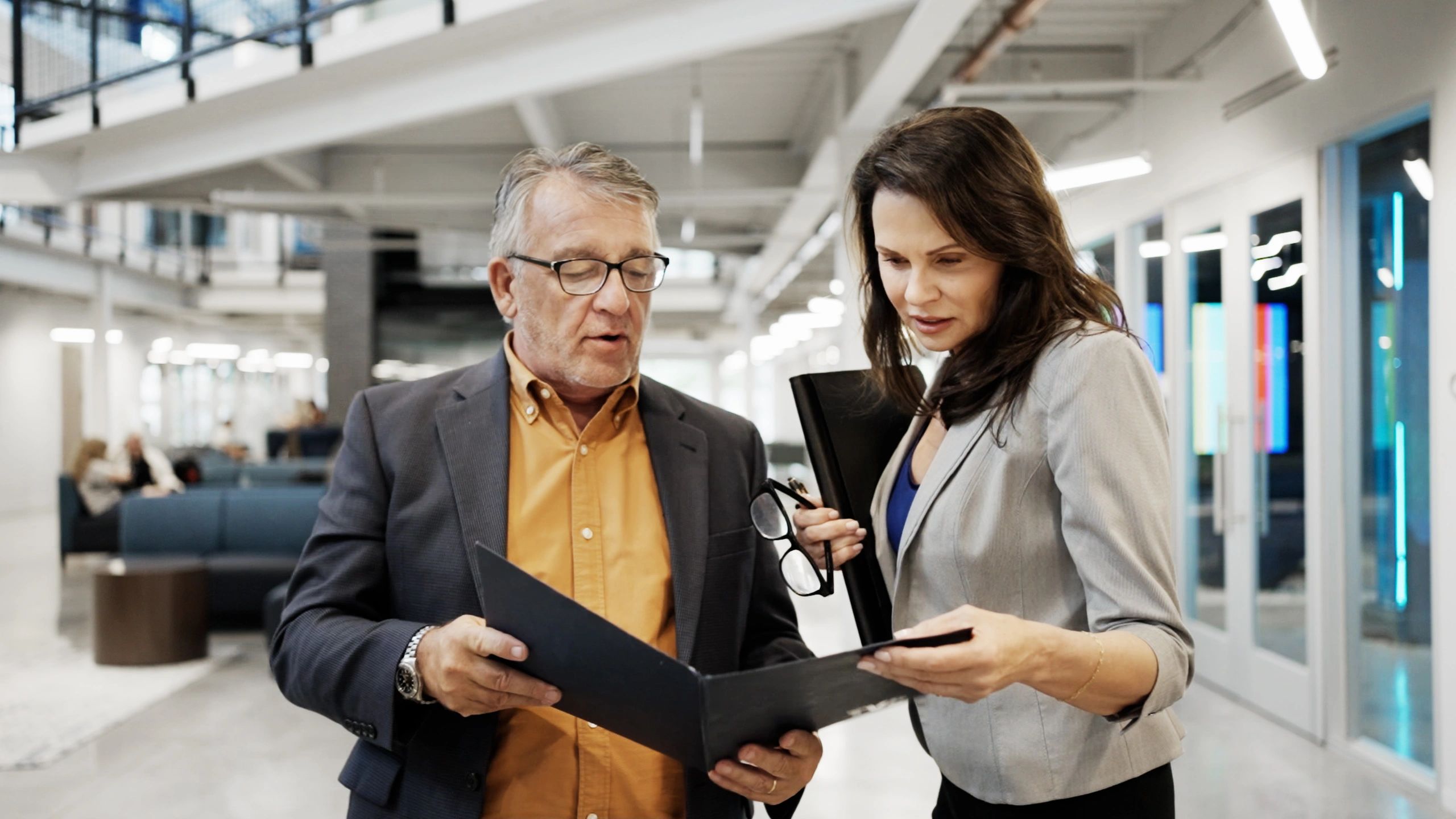 Two professionals reviewing an assessment or report together