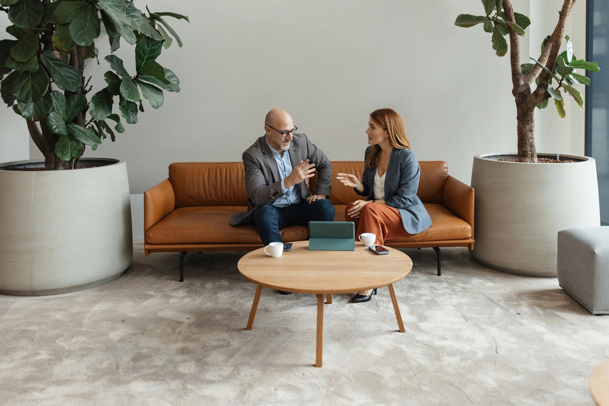 Two professionals reviewing information together on a tablet