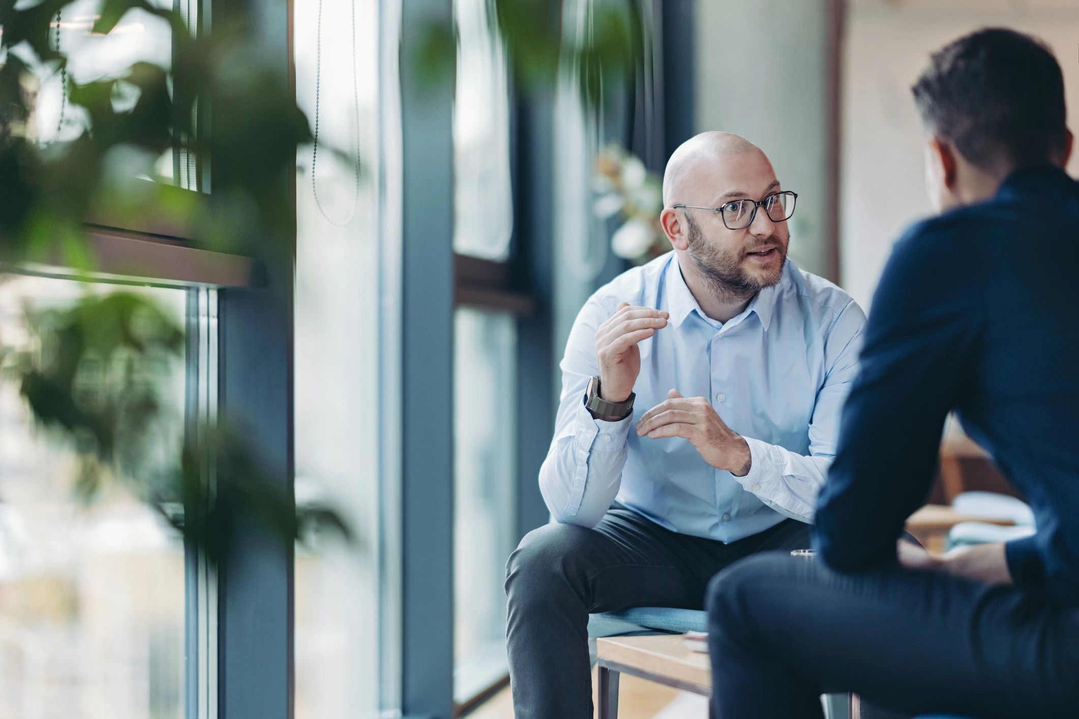 Two professionals in conversation in an office setting